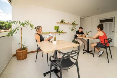 a group of people sitting at tables in a room at Tu Espacio Privado en Medellín E in Medellín
