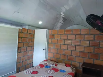 a room with a brick wall and a bed at casa de relajacion lowcost in La Dorada