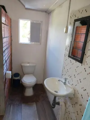 a bathroom with a toilet and a sink at casa de relajacion lowcost in La Dorada