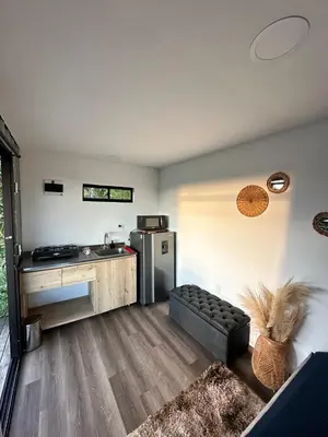 a living room with a sink and a refrigerator at Alto Paraiso Glamping 