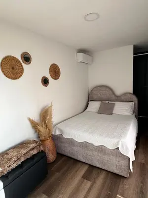 a bedroom with a bed and some baskets on the wall at Alto Paraiso Glamping 