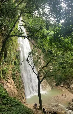 a waterfall in the middle of a river at Glamping A-MAR in Cocorná