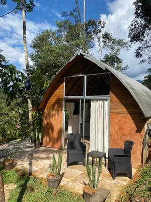 a gazebo with two chairs and a table at Glamping A-MAR in Cocorná
