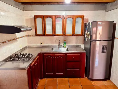 a kitchen with a sink and a refrigerator at Next to the airport - cute home in Rionegro