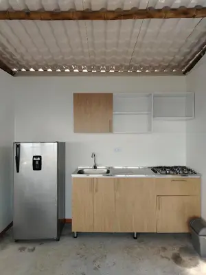 a kitchen with a sink and a refrigerator at Glamping Orosierra in Chinchiná