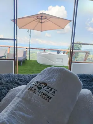 a towel sitting on top of a bed with an umbrella at Glamping Orosierra in Chinchiná