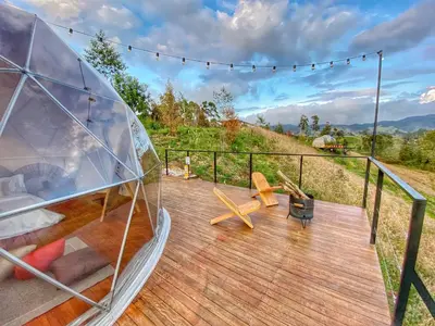 a wooden deck with a glass dome on it at Bohemia Glamping in La Unión