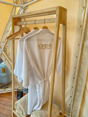 a white shirt on a rack in a room at Bohemia Glamping in La Unión
