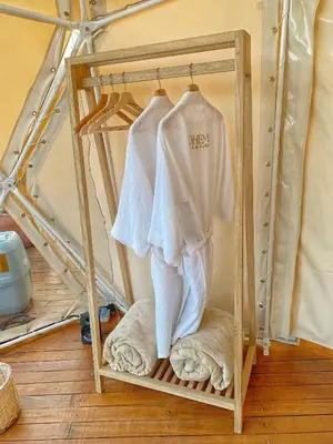 a shelf with a white shirt and towels on it at Bohemia Glamping in La Unión