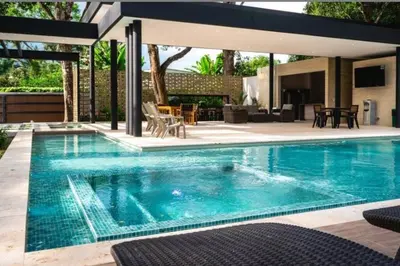 a swimming pool with blue water in a backyard at Finca Luxury (Casa Creta) - Santa fé de Antioquia in Sopetran