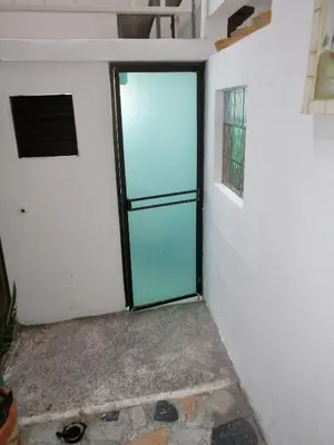 a glass door in a room with a wall at Casa lowcost relajación in La Dorada