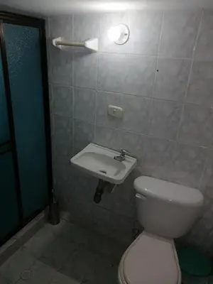 a bathroom with a toilet and a sink at Casa lowcost relajación in La Dorada
