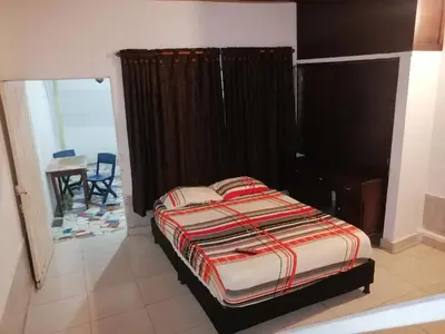 a bedroom with a bed and a table in a room at Casa lowcost relajación in La Dorada