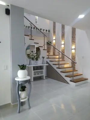 a room with a staircase with a sink and a mirror at ALAMEDA MI DESCANSO in Carmen de Viboral