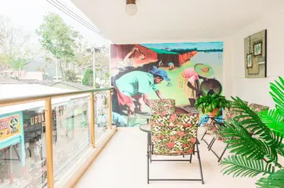 a room with a balcony with a mural on the wall at HOTEL FUENTE DE ORO in Amalfi