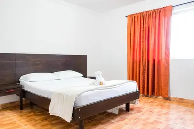 a bedroom with a bed and a red curtain at HOTEL FUENTE DE ORO in Amalfi
