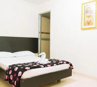 a bedroom with a bed with a stuffed swan on it at HOTEL FUENTE DE ORO in Amalfi
