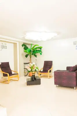 a living room with two couches and a plant at HOTEL FUENTE DE ORO in Amalfi