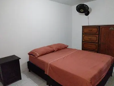a bedroom with a bed and a dresser at casa la magdalena in La Dorada