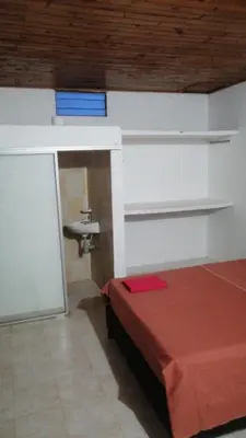 a room with a bed and a sink in it at casa la magdalena in La Dorada