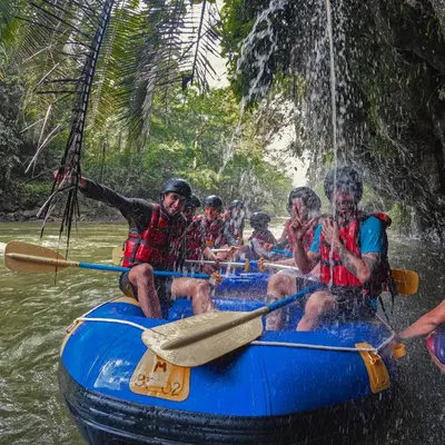 a group of people on a raft in the water at Glamping Río Claro in Doradal