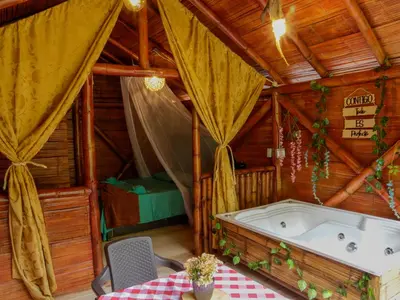 a bath tub in a room with a table at Glamping Río Claro in Doradal