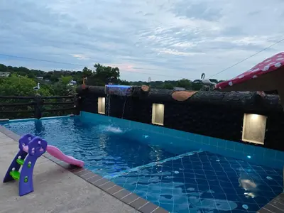 a pool with a water slide in a house at Casa Del Árbol in Doradal