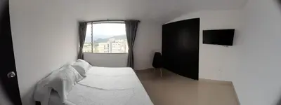 a white bedroom with a bed and a window at Casa Colibrí Hospedaje Manizales a 2 min del Cable y 1 min Zona G in Manizales