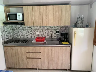 a kitchen with a sink and a white refrigerator at Jardín de la Inmaculada - a 8min del parque in Jardin