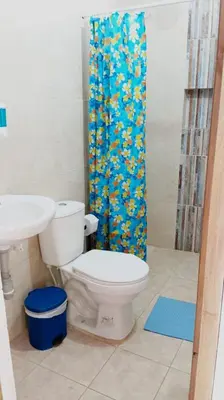 a bathroom with a toilet and a shower curtain at Jardín de la Inmaculada - a 8min del parque in Jardin