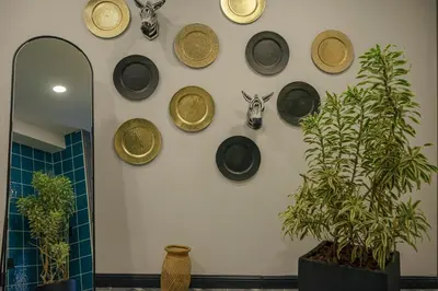 a wall with a bunch of hats on a wall at First Class Hotel in Medellín
