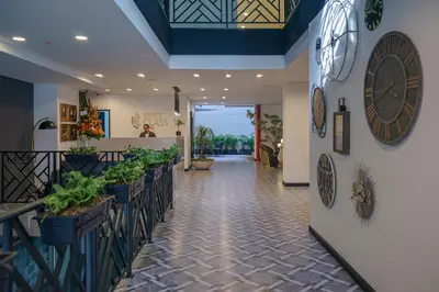 a lobby of a restaurant with plants on the walls at First Class Hotel in Medellín