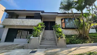 a house with stairs leading to the front door at Las Lomas Luxury House in Medellín