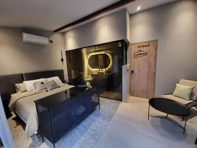 a bedroom with a bed and a desk and a chair at Las Lomas Luxury House in Medellín
