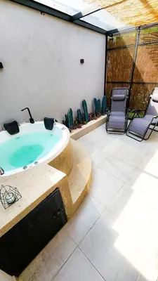 a jacuzzi tub in the middle of a patio at Las Lomas Luxury House in Medellín