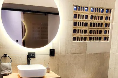 a bathroom with a sink and a mirror at Las Lomas Luxury House in Medellín
