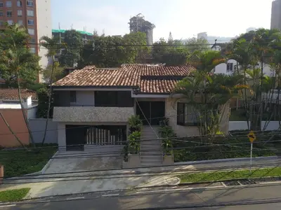 a house with a tiled roof on a city street at Las Lomas Luxury House in Medellín