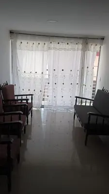 a room with a row of chairs and curtains at casa 4 cocorna in Cocorná
