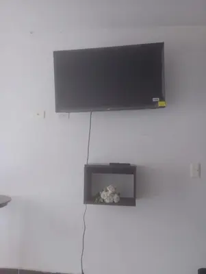 a flat screen tv hanging on a wall at casa 4 cocorna in Cocorná