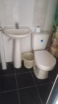 a bathroom with a white toilet and a sink at casa 4 cocorna in Cocorná