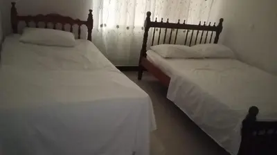two beds sitting next to each other in a bedroom at casa 4 cocorna in Cocorná