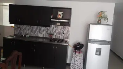 a kitchen with a white refrigerator and a microwave at casa 4 cocorna in Cocorná