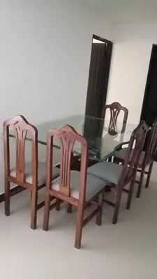 a glass table with four wooden chairs and a glass table with a glass table at casa 4 cocorna in Cocorná