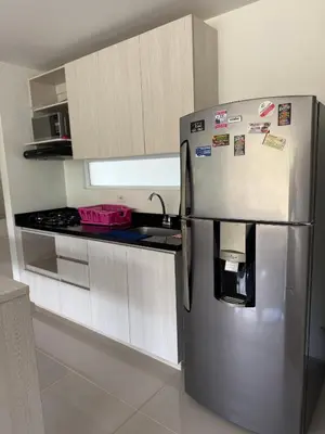 a kitchen with a stainless steel refrigerator and a sink at Citadela Disole Paraíso in Santa Fe de Antioquia