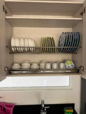 a kitchen shelf with plates and bowls and a sink at Citadela Disole Paraíso in Santa Fe de Antioquia