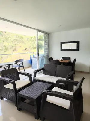a room with chairs and tables and a large window at Citadela Disole Paraíso in Santa Fe de Antioquia