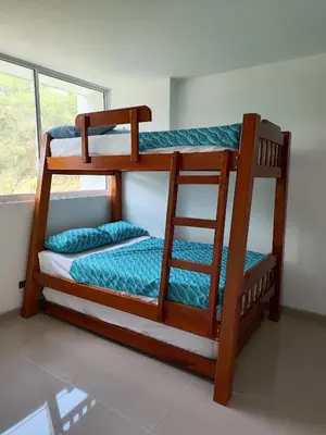 two bunk beds in a room with a window at Citadela Disole Paraíso in Santa Fe de Antioquia