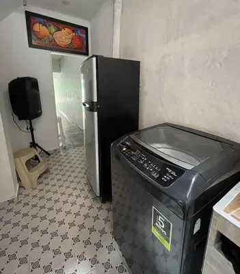 a kitchen with a refrigerator and a trash can at Apartamento vacacional galeón 2 Doradal in Doradal