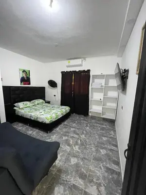 a small room with two beds and a shelf at Apartamento vacacional galeón 2 Doradal in Doradal