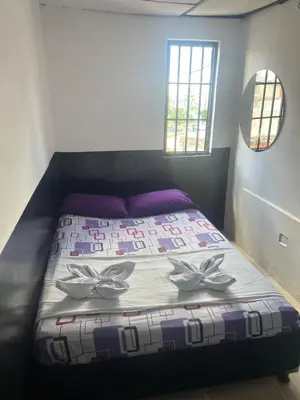 a bed in a room with two butterflies on it at El Amanecer Parque Del Agua in Manizales